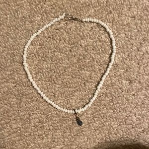 WHITE NECKLACE WITH BLUE CHARM